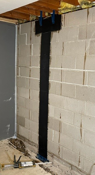 Professional technician performing crackrepair on damaged wall in Lake Leelanau home.