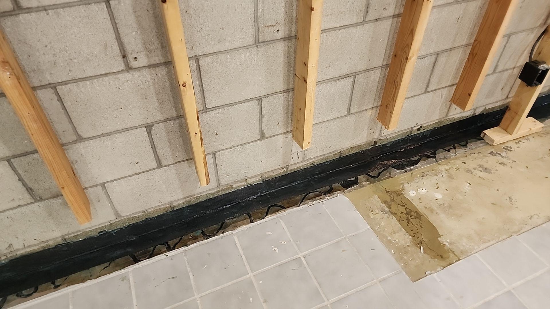 A technician repairing a crack in a residential wall in Standish, Michigan.