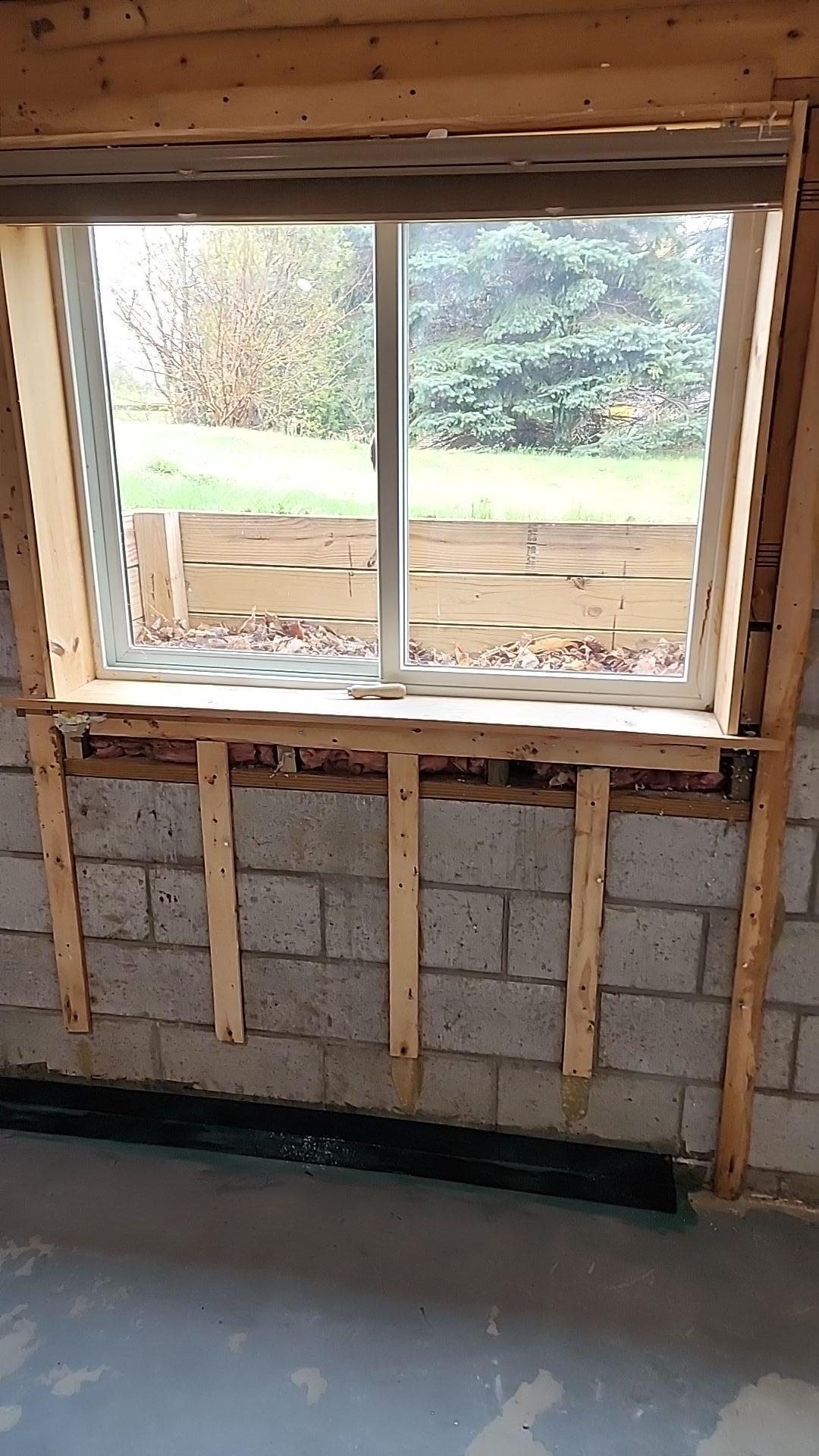 A professional repairing a wall crack in a home located in Big Rapids, Michigan.