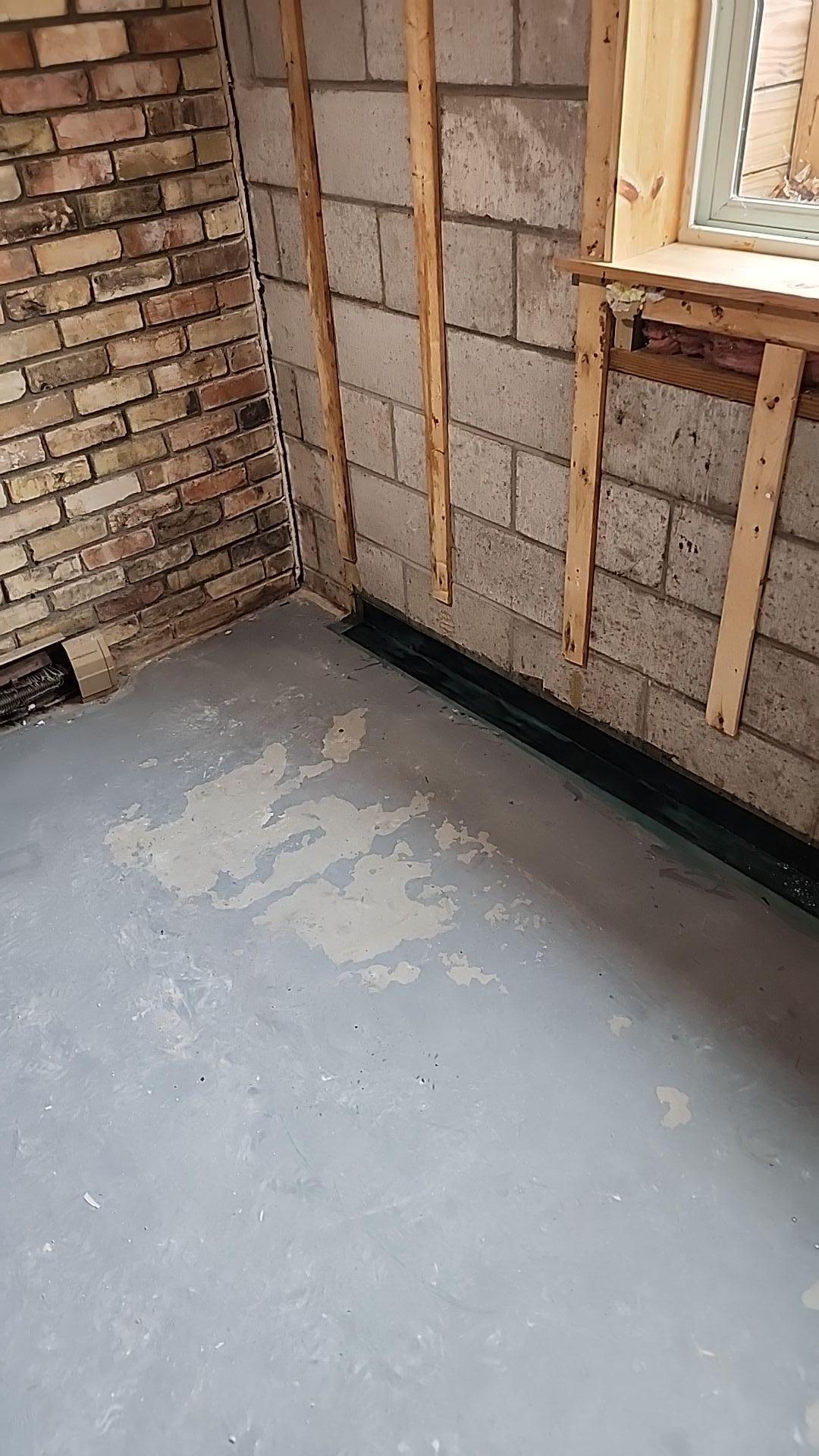 A contractor applying professional crackrepair to a residential foundation in Dorr, Michigan.
