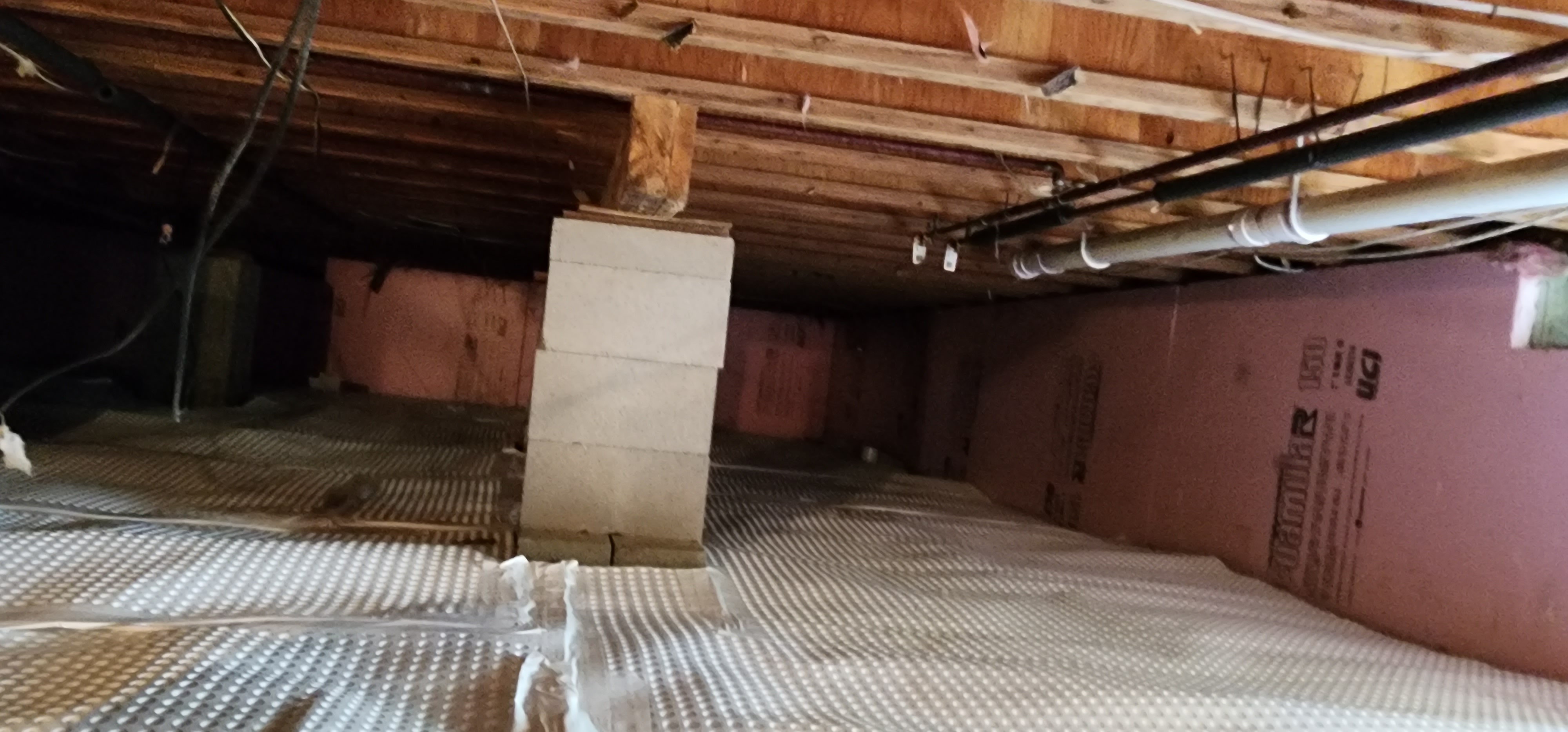 Crawlspace encapsulation process in a home in Honor, Michigan.