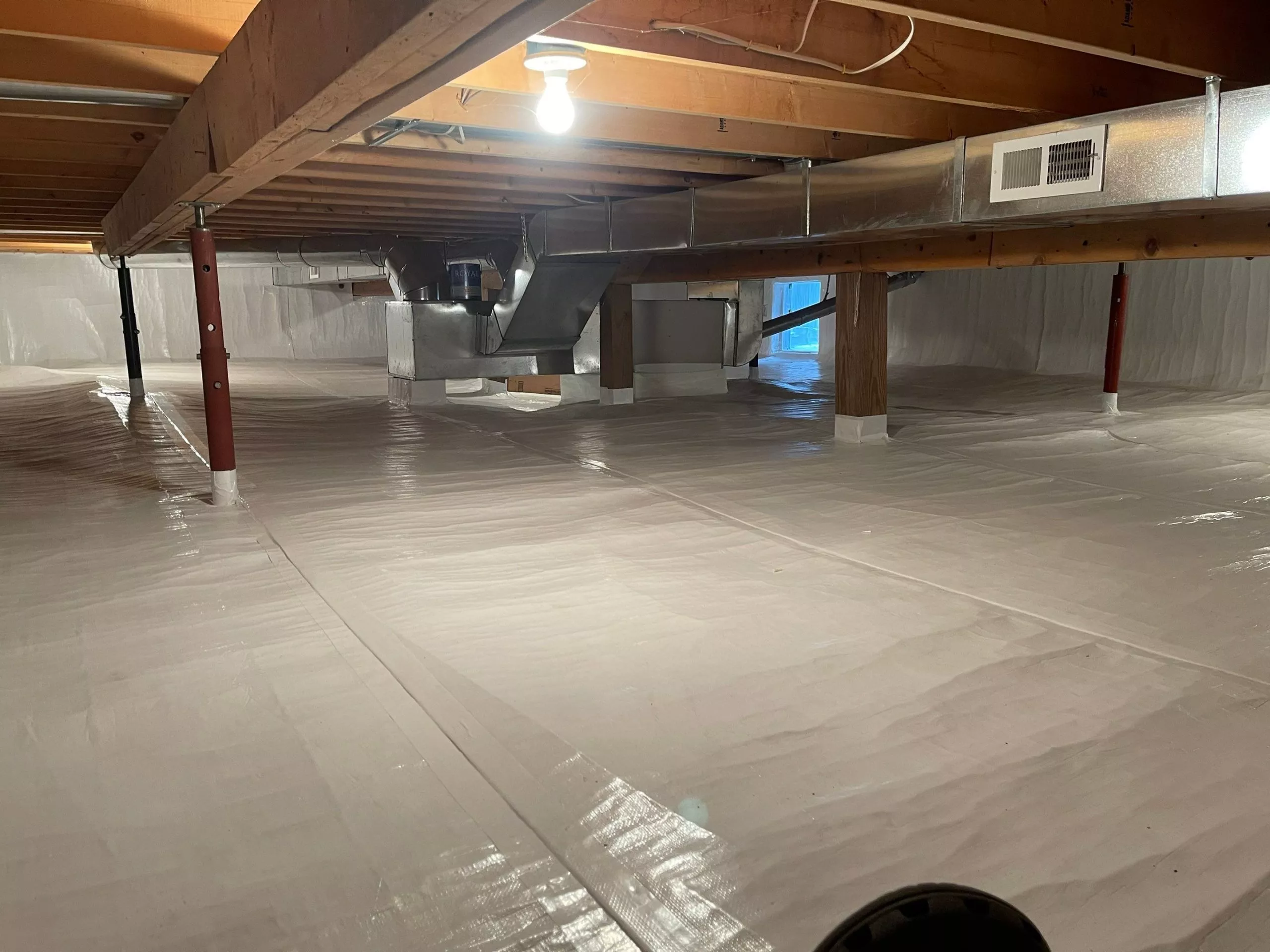 Crawlspace encapsulation process showing a cleaner, moisture-free space.