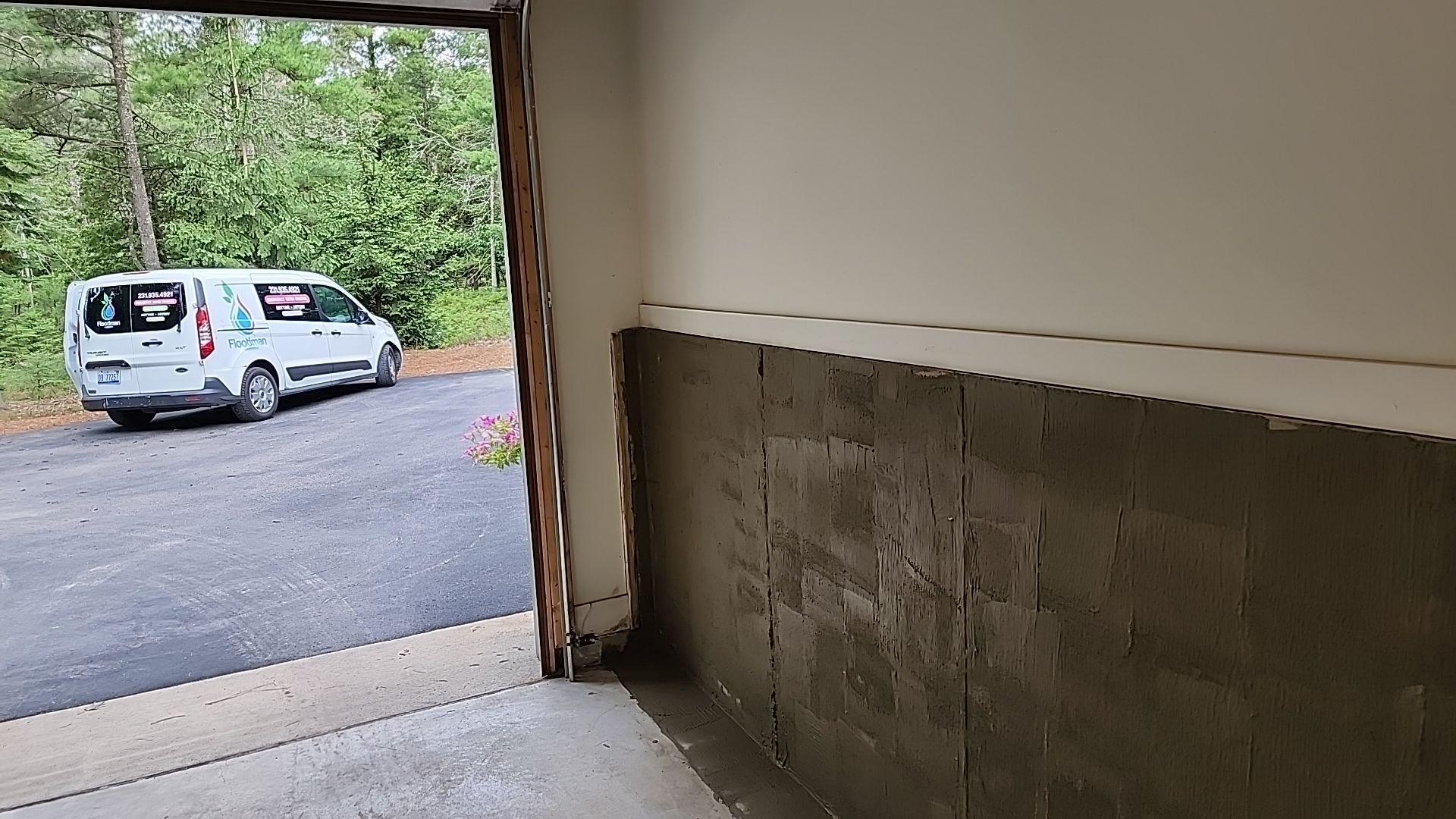 Waterproofing expert applying a sealant to a basement wall